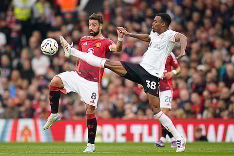 English Premier League 2024-25 Liverpool vs Manchester United: Manchester United's Bruno Fernandes, left, challenges for the ball with Liverpool's Ryan Gravenberch